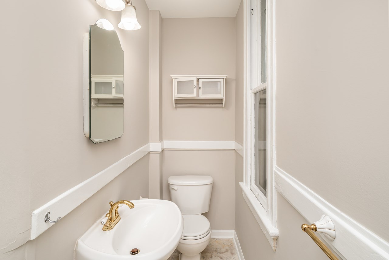 109 North Bloodworth Street Raleigh, NC 27601 - Photo 20 of 30 a bathroom with a toilet and a sink