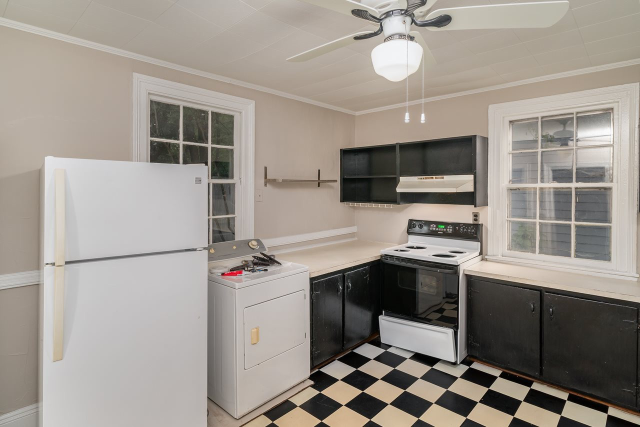 109 North Bloodworth Street Raleigh, NC 27601 - Photo 26 of 30 a kitchen with a refrigerator sink and white cabinets