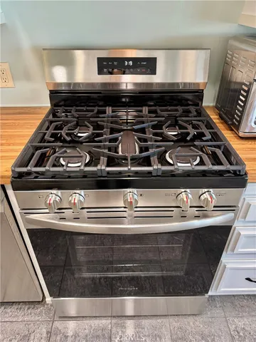 a view of a kitchen with cabinets and wooden floor