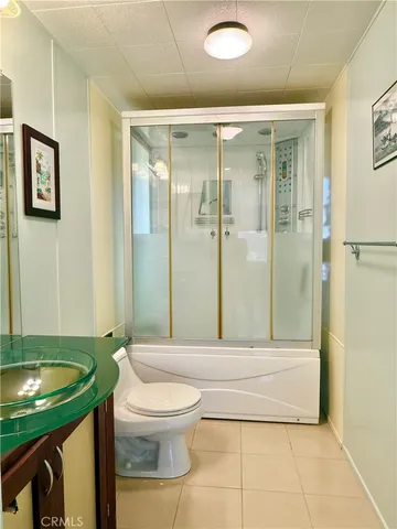 a bedroom with a bed and a mirror