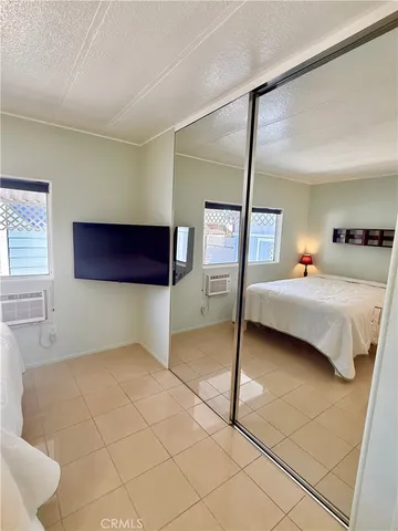 a bed room with a bed and a tv