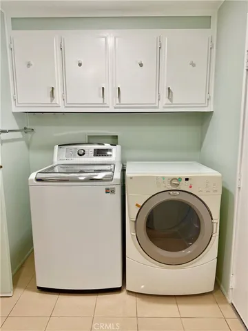 a utility room with sink dryer and washer