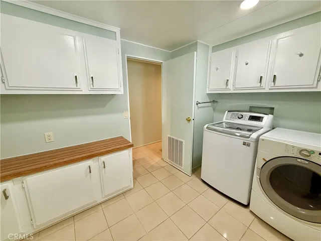 a view of a kitchen with a sink dishwasher and wooden floor