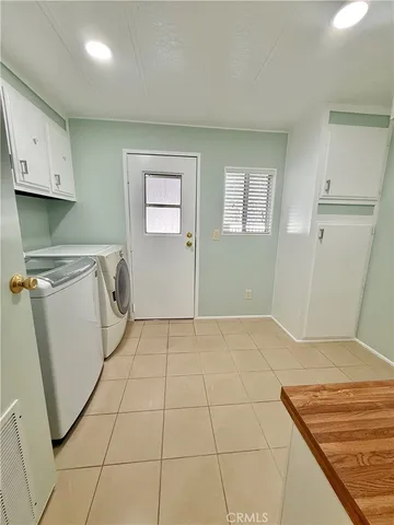 a view of a kitchen with white cabinets
