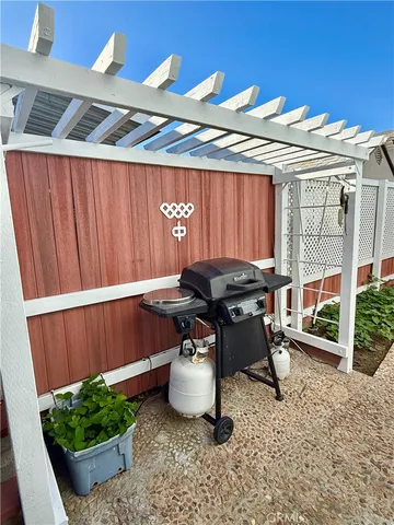 a view of a patio with table and chairs and potted plants
