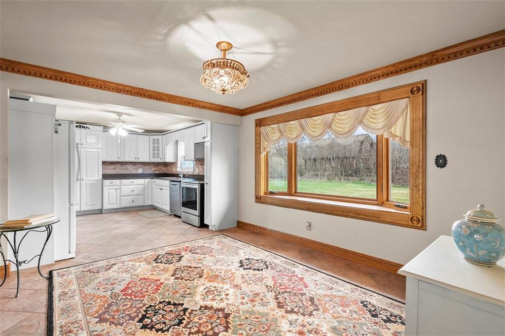 391 Golden Grove Road Baden, PA 15005 - Photo 14 of 34 a view of a kitchen with a stove cabinets and a wooden floor