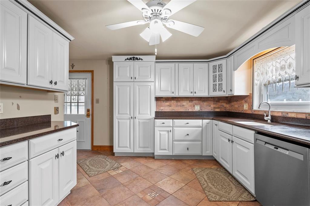 391 Golden Grove Road Baden, PA 15005 - Photo 17 of 34 a kitchen with white cabinets and white appliances