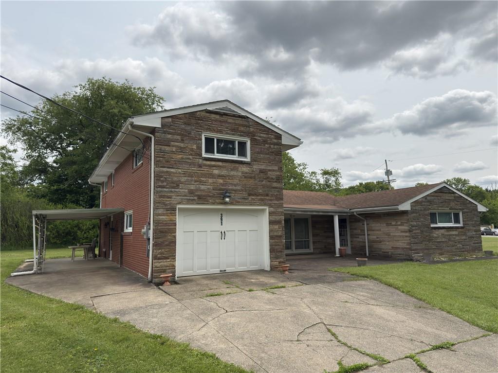 391 Golden Grove Road Baden, PA 15005 - Photo 2 of 34 a front view of a house with a garden and garage