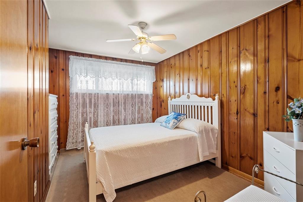 391 Golden Grove Road Baden, PA 15005 - Photo 24 of 34 a bedroom with a bed and a chandelier