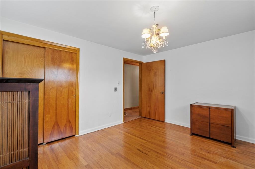 391 Golden Grove Road Baden, PA 15005 - Photo 26 of 34 a view of an empty room with wooden floor and a window