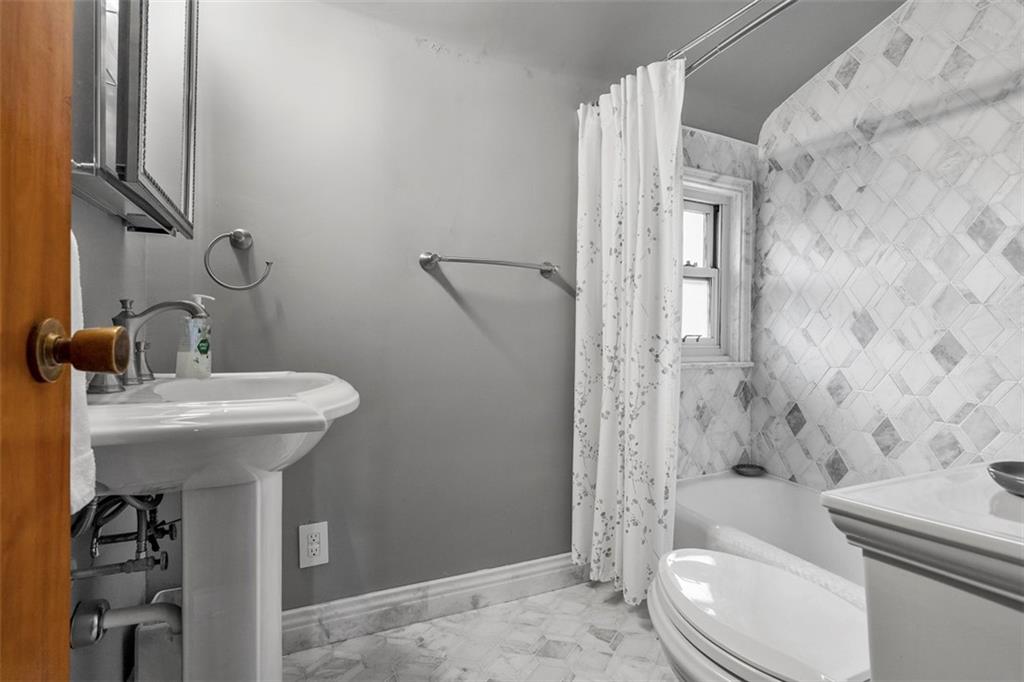 391 Golden Grove Road Baden, PA 15005 - Photo 31 of 34 a bathroom with a sink a toilet and shower