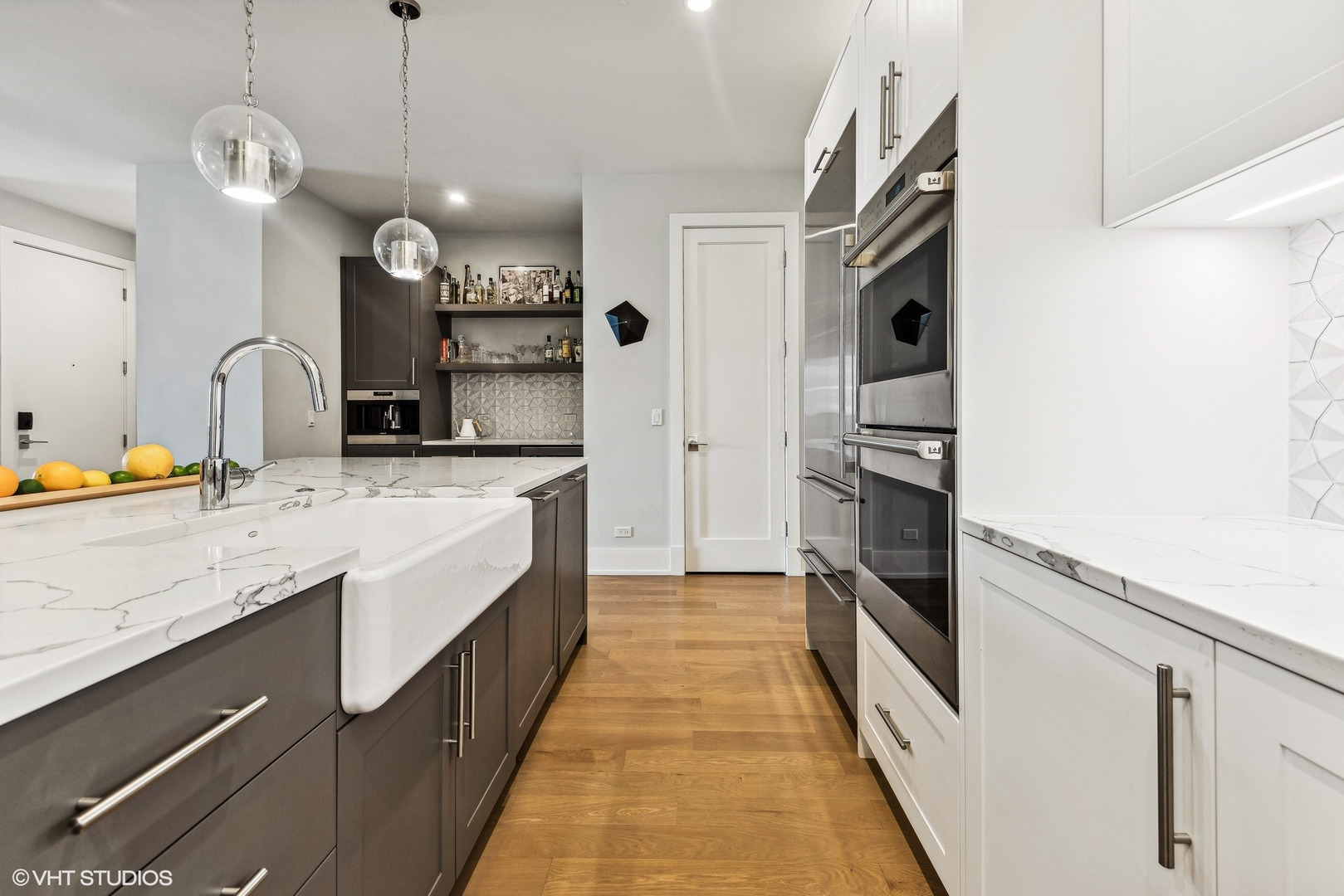 220 South Green Street, Unit 3N Chicago, IL 60607 - Photo 11 of 34 a large kitchen with stainless steel appliances granite countertop a sink and a refrigerator