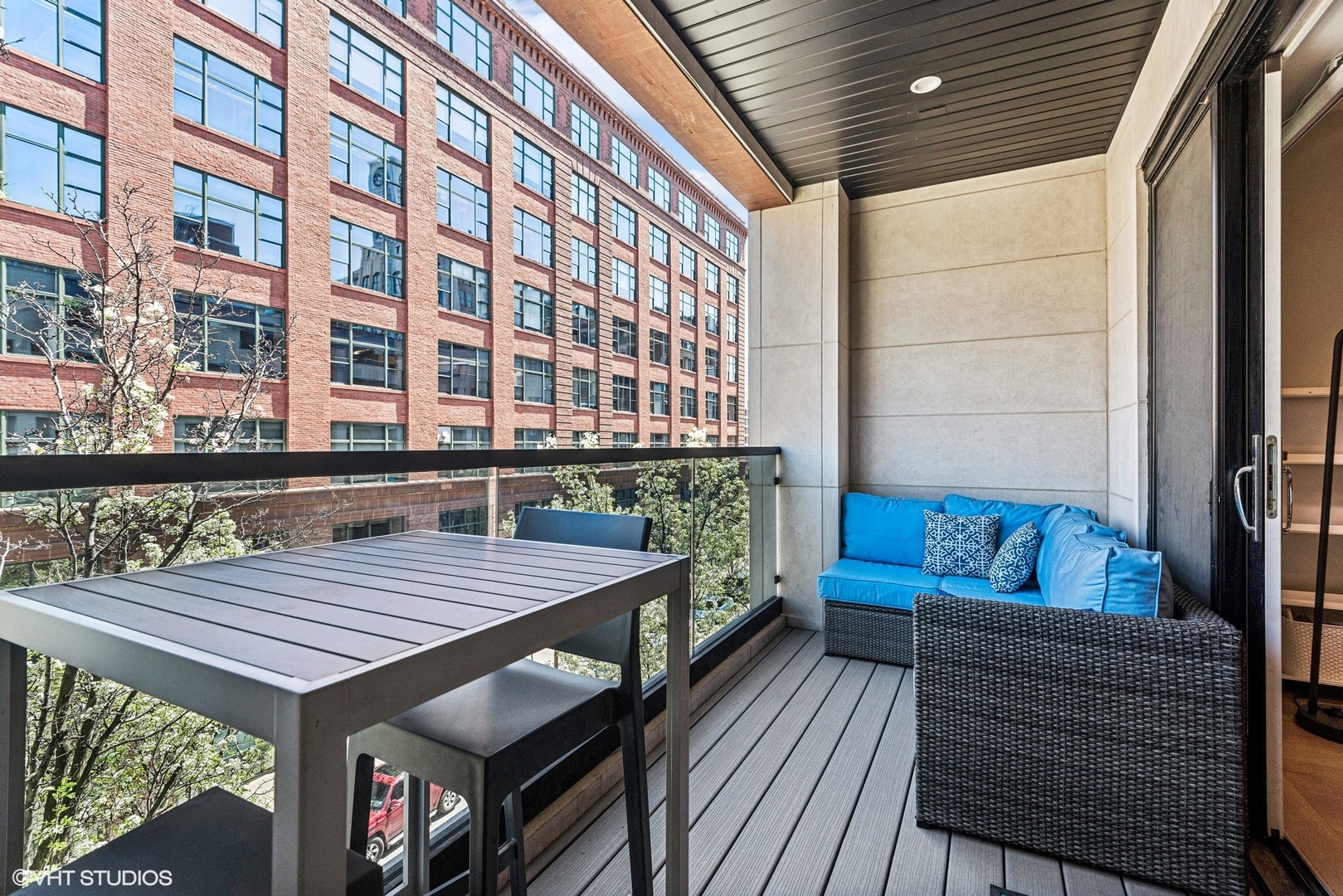 220 South Green Street, Unit 3N Chicago, IL 60607 - Photo 29 of 34 a view of a balcony with couch and wooden floor