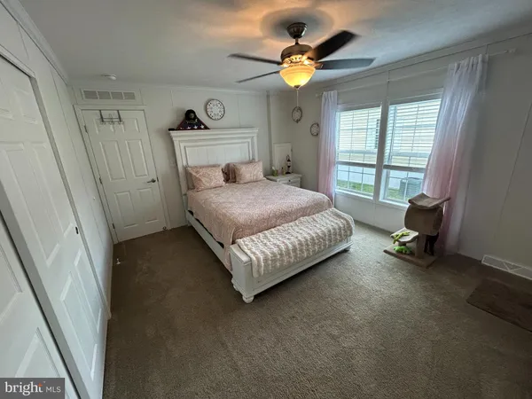 a bedroom with a bed chair and a window
