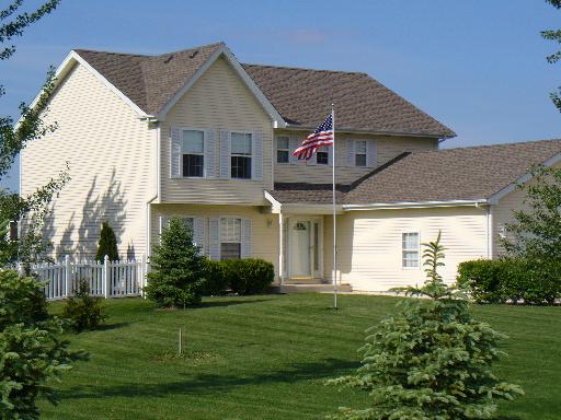 9520 West Pauling Road Monee, IL 60449 - Photo 1 of 1 a view of a white house next to a yard with potted plants