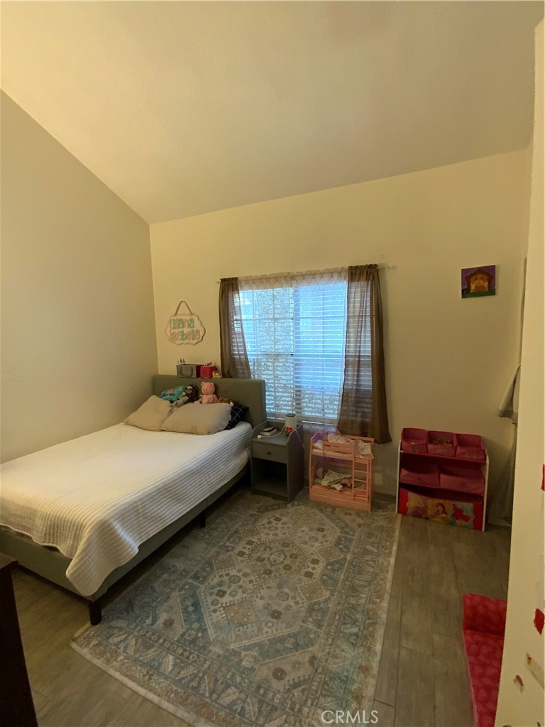 4140 Workman Mill Road, Unit 172 Whittier, CA 90601 - Photo 18 of 21 a bedroom with a bed and a chair