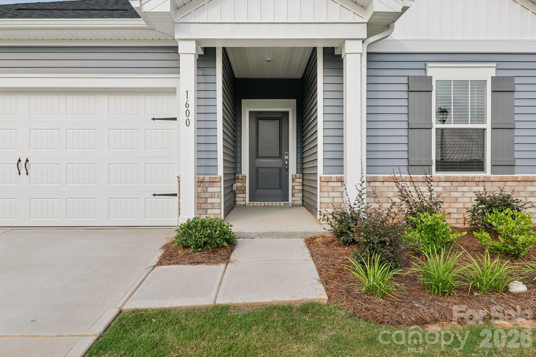 2449 Chartwell Street Stanley, NC 28164 - Photo 1 of 23 a front view of a house with garden
