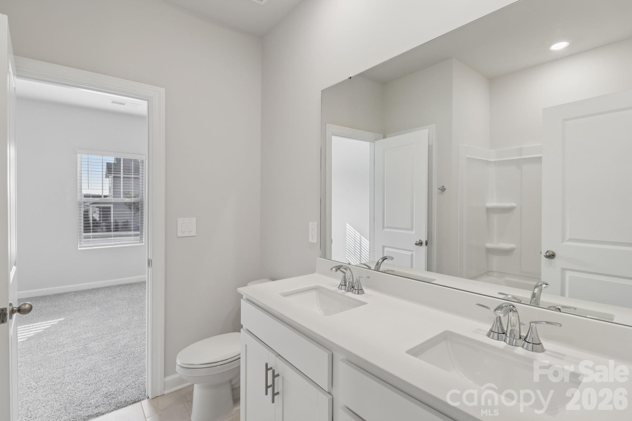2449 Chartwell Street Stanley, NC 28164 - Photo 17 of 23 a bathroom with a sink toilet and shower