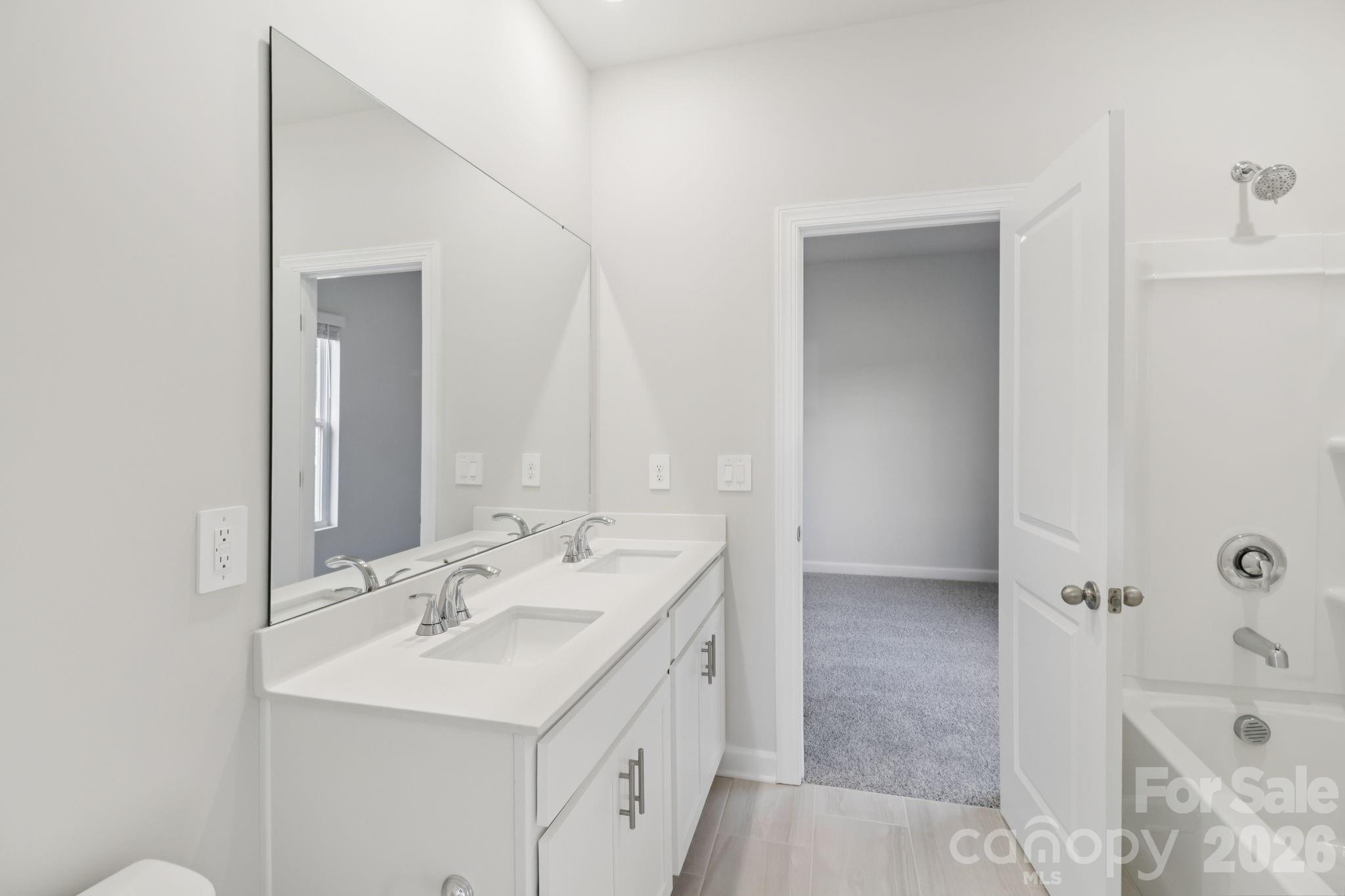 2449 Chartwell Street Stanley, NC 28164 - Photo 21 of 23 a bathroom with a tub sink and mirror