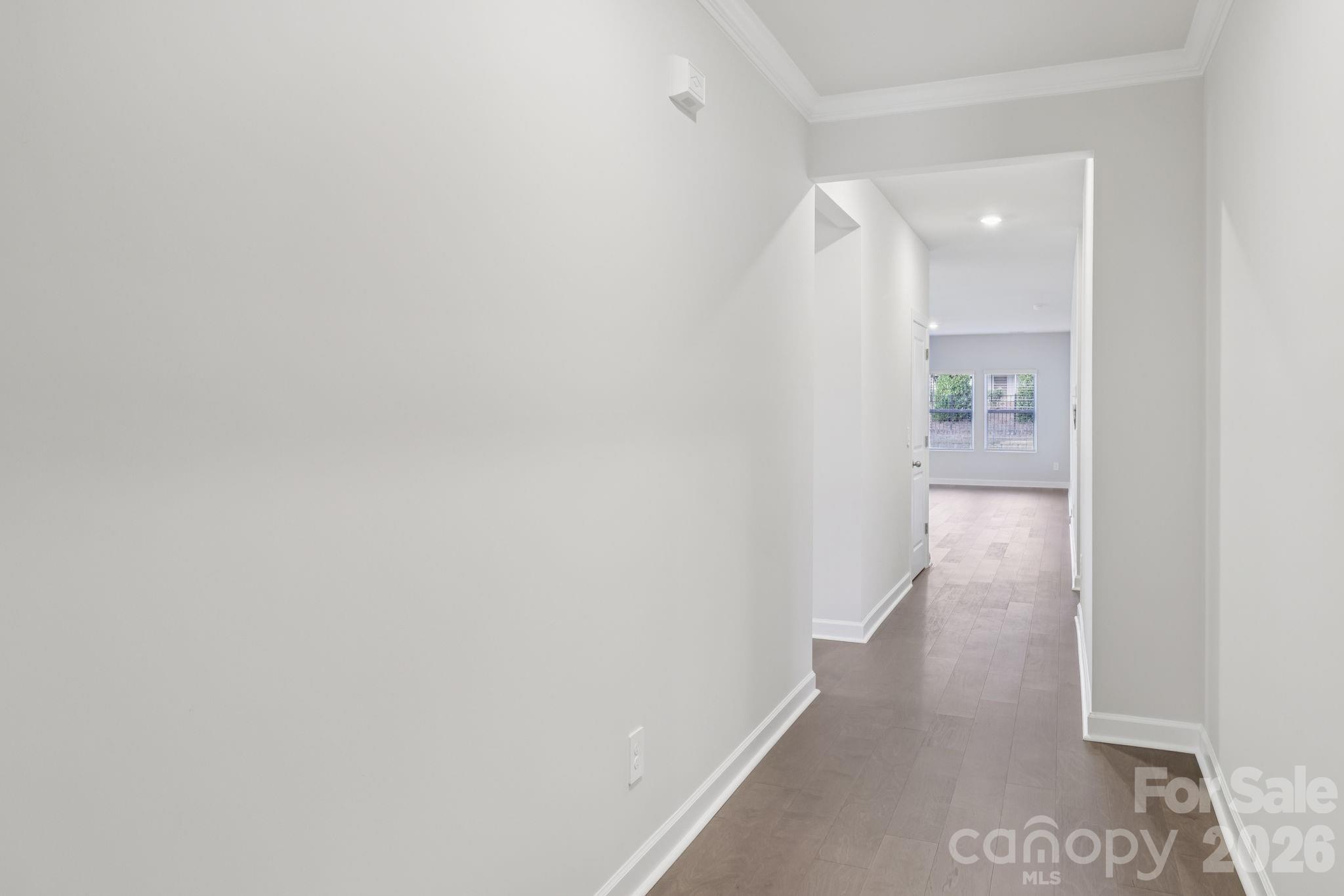 2449 Chartwell Street Stanley, NC 28164 - Photo 4 of 23 a view of a hallway with wooden floor