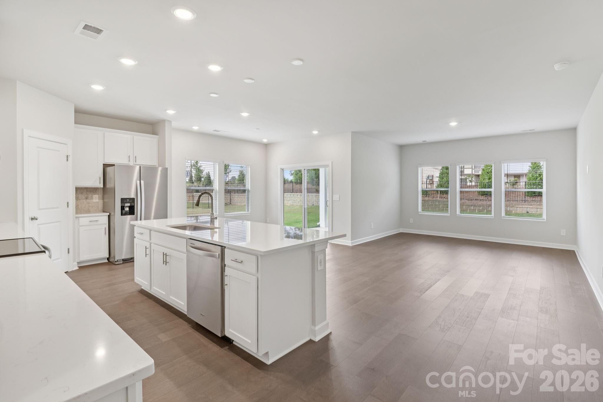 2449 Chartwell Street Stanley, NC 28164 - Photo 7 of 23 a large kitchen with stainless steel appliances granite countertop a large counter top a stove and a refrigerator