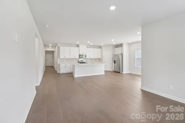 a view of a kitchen with refrigerator and a sink