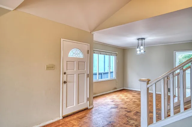wooden floor in an empty room with a window