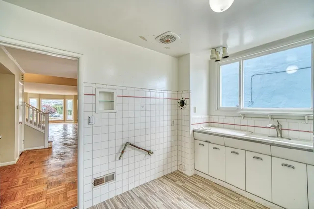 a spacious bathroom with a shower sink and mirror
