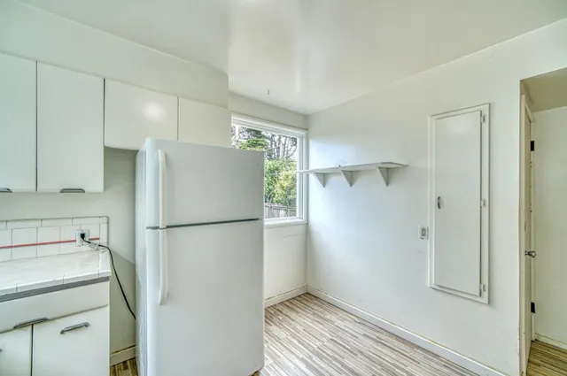 a white refrigerator freezer sitting inside of a kitchen