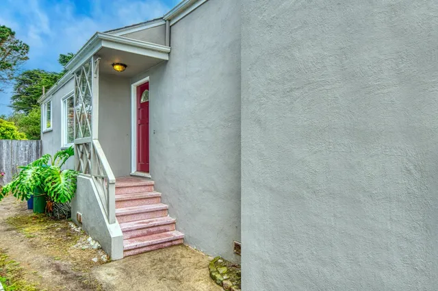 a front view of a house with a garden