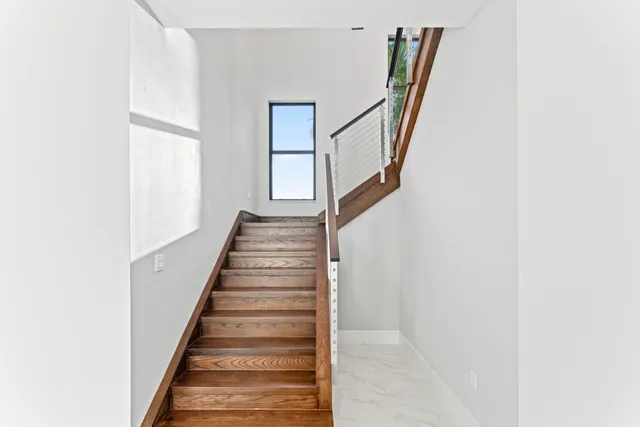 a view of an entryway with wooden floor