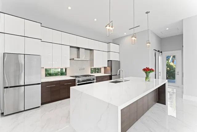 a living room with furniture potted plant and a large window