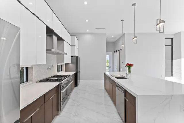 an empty room with windows and ceiling fan