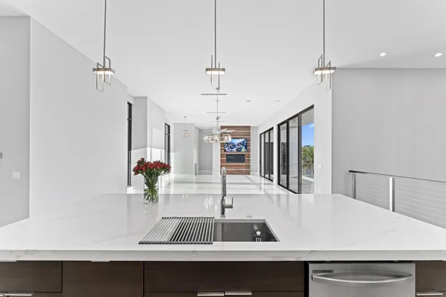 a spacious bedroom with a large bed and a chandelier