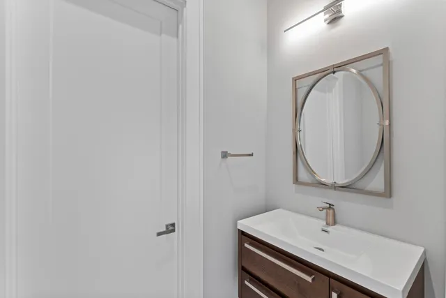 a bathroom with a sink toilet a mirror and shower