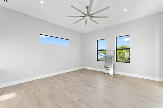 wooden floor in an empty room with a window