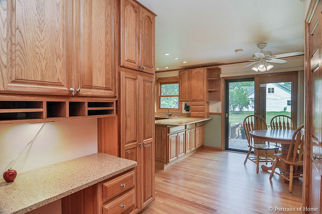 N549 Pleasant Hill Road Wheaton, IL 60187 - Photo 8 of 25 a kitchen with a wooden floor and chairs