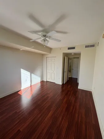 a view of empty room with wooden floor