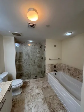 a bathroom with a bathtub and a shower