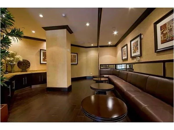 a kitchen with stainless steel appliances lots of counter space and furniture