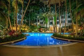 a view of a backyard with swimming pool and plants