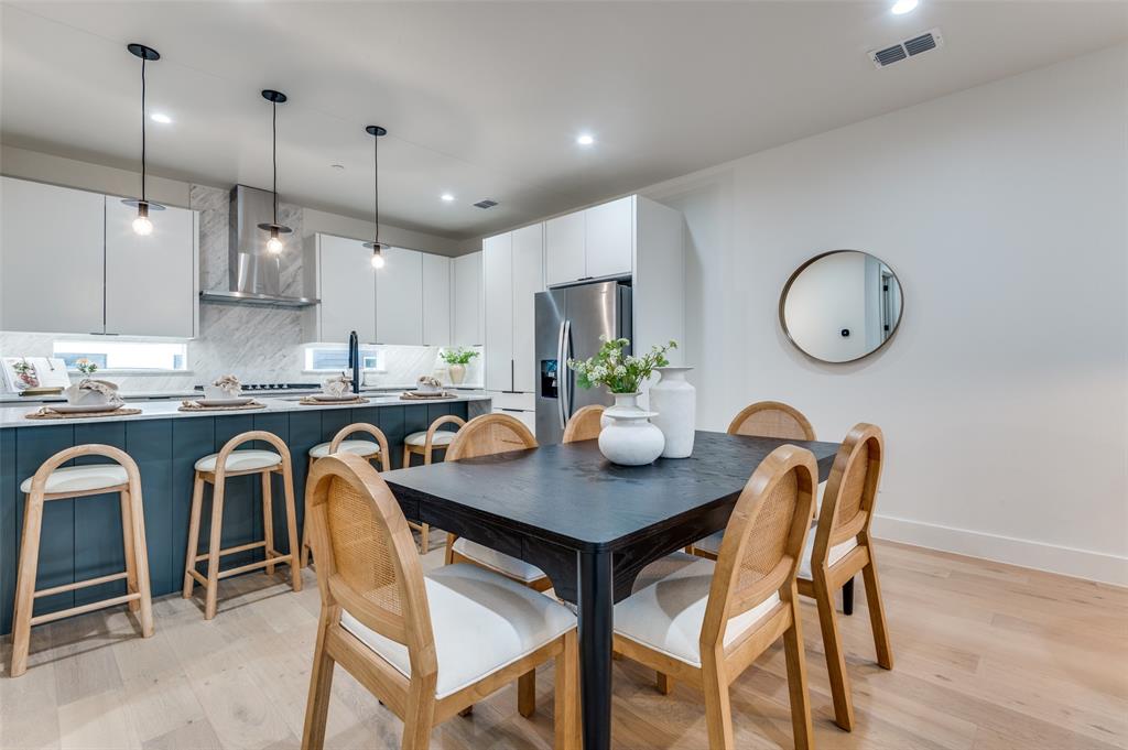 1147 North Madison Avenue, Unit 102 Dallas, TX 75208 - Photo 4 of 24 Dining area plus barstool seating in the kitchen.