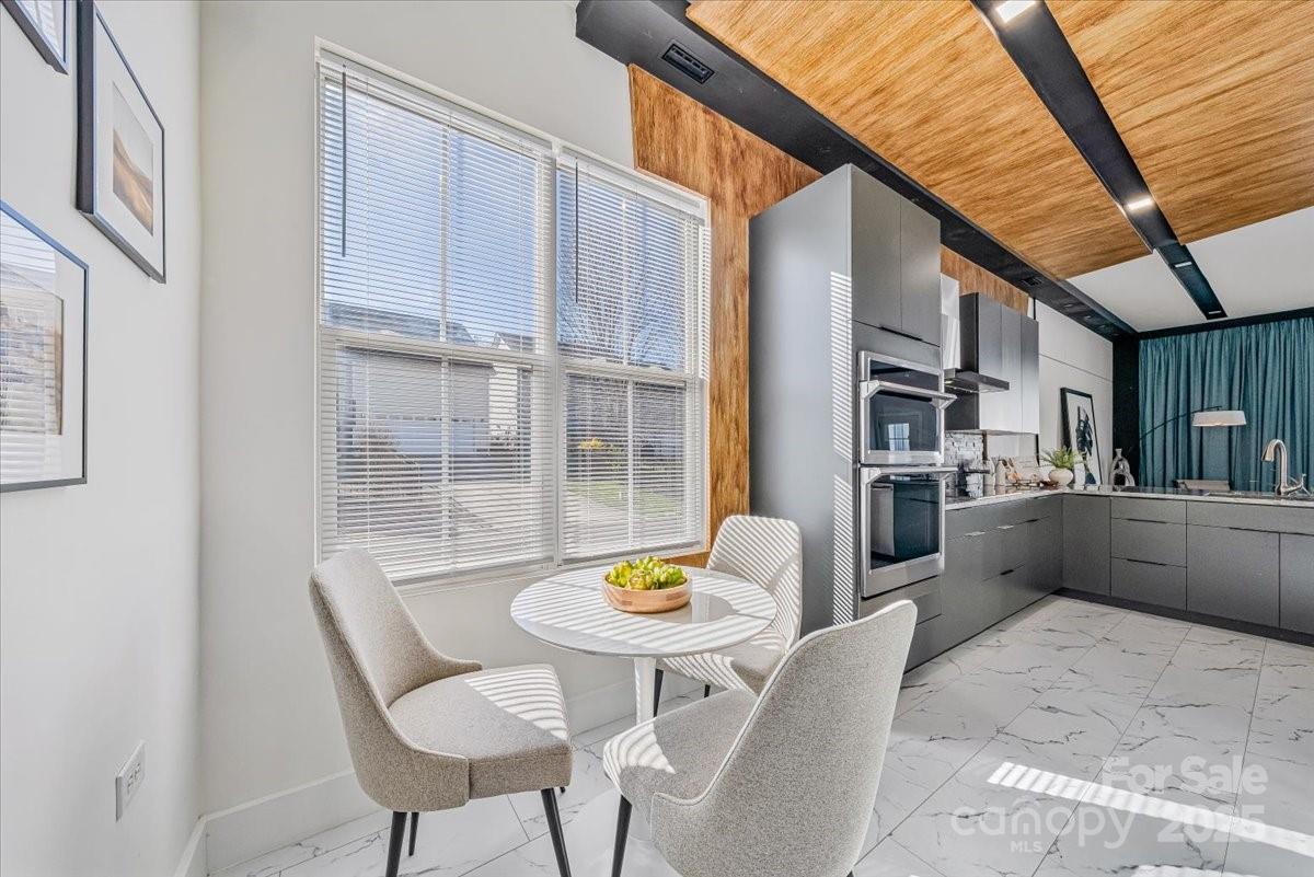6517 Old Magnolia Lane Mint Hill, NC 28227 - Photo 11 of 46 a kitchen with stainless steel appliances granite countertop a dining table chairs and a refrigerator