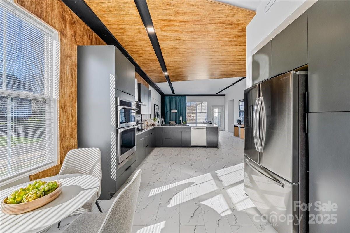 6517 Old Magnolia Lane Mint Hill, NC 28227 - Photo 12 of 46 a kitchen with stainless steel appliances kitchen island granite countertop a refrigerator and a stove