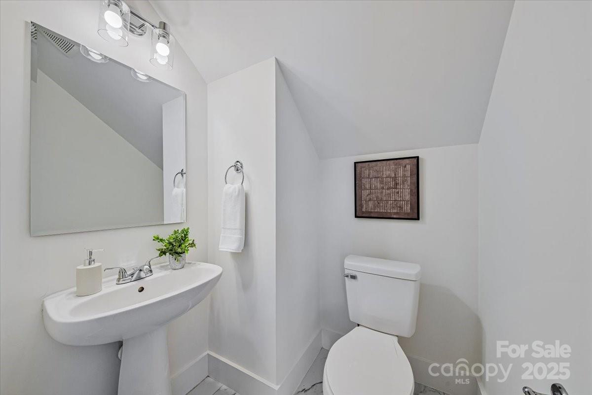6517 Old Magnolia Lane Mint Hill, NC 28227 - Photo 20 of 46 a bathroom with a toilet sink and mirror