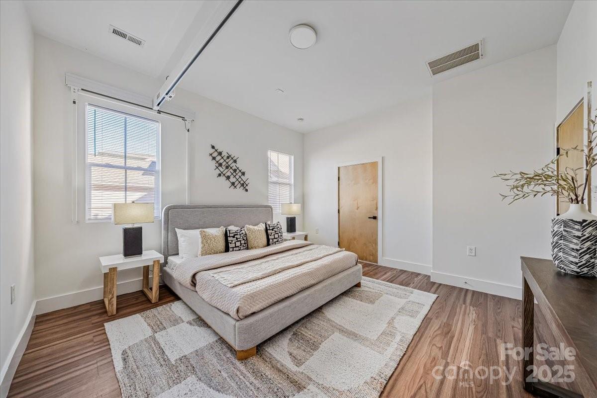 6517 Old Magnolia Lane Mint Hill, NC 28227 - Photo 23 of 46 a bedroom with a large bed and a wooden floor