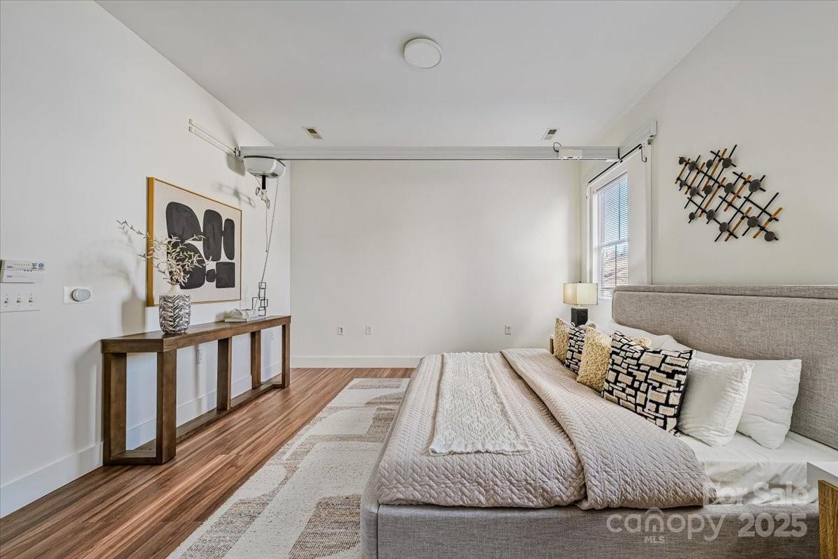 6517 Old Magnolia Lane Mint Hill, NC 28227 - Photo 24 of 46 a bedroom with a large bed and a wooden floor