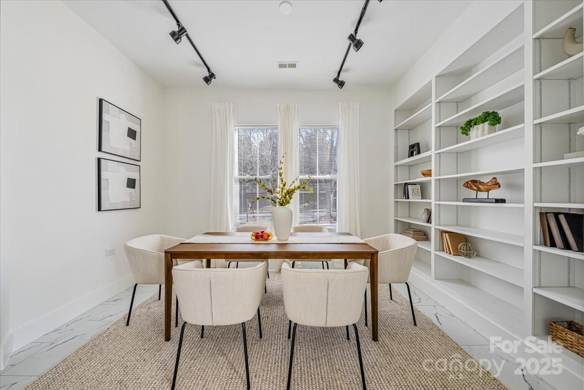 6517 Old Magnolia Lane Mint Hill, NC 28227 - Photo 6 of 46 a view of a dining room with furniture and a book shelf