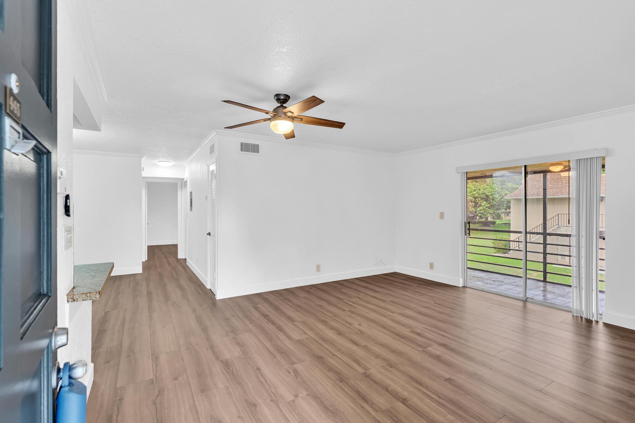 1291 Northwest 13th Street, Unit 445D Boca Raton, FL 33486 - Photo 6 of 50 an empty room with wooden floor and windows