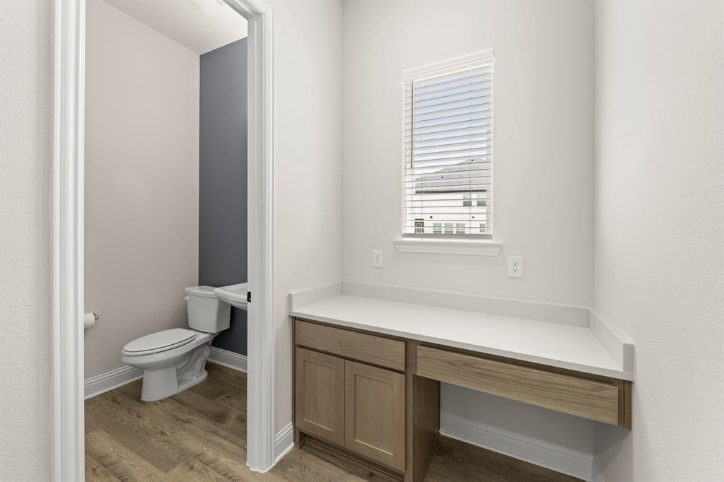 3900 Keya Drive Prosper, TX 75078 - Photo 19 of 36 a bathroom with a sink a toilet and a window